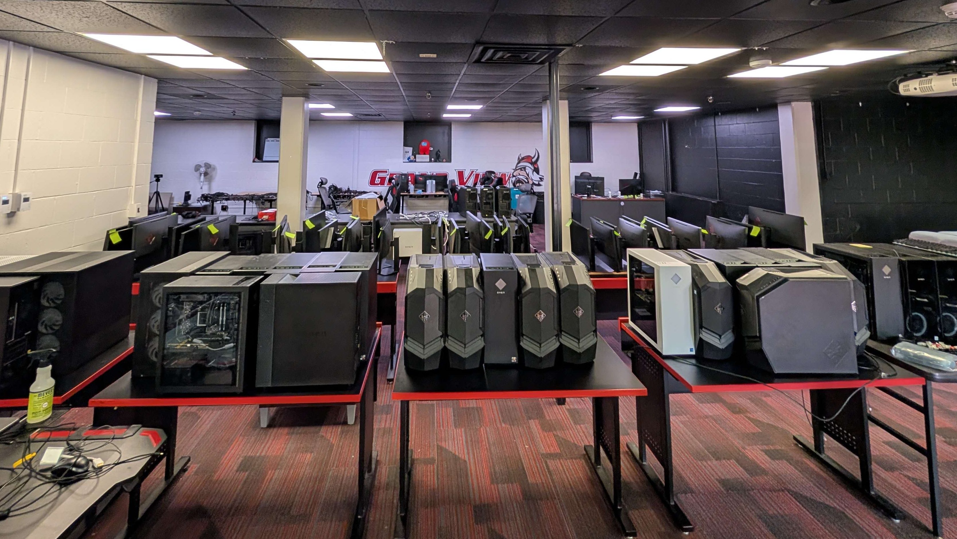 Grand View Esports with lots of PCs removed from plugs and placed on various tables.